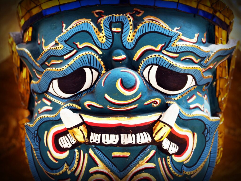 Bright and colorful traditional Asian mask with intricate details and bold colors.